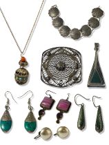 A large amount of silver jewellery including a brooch, drop earrings and pendants weighing 63.95