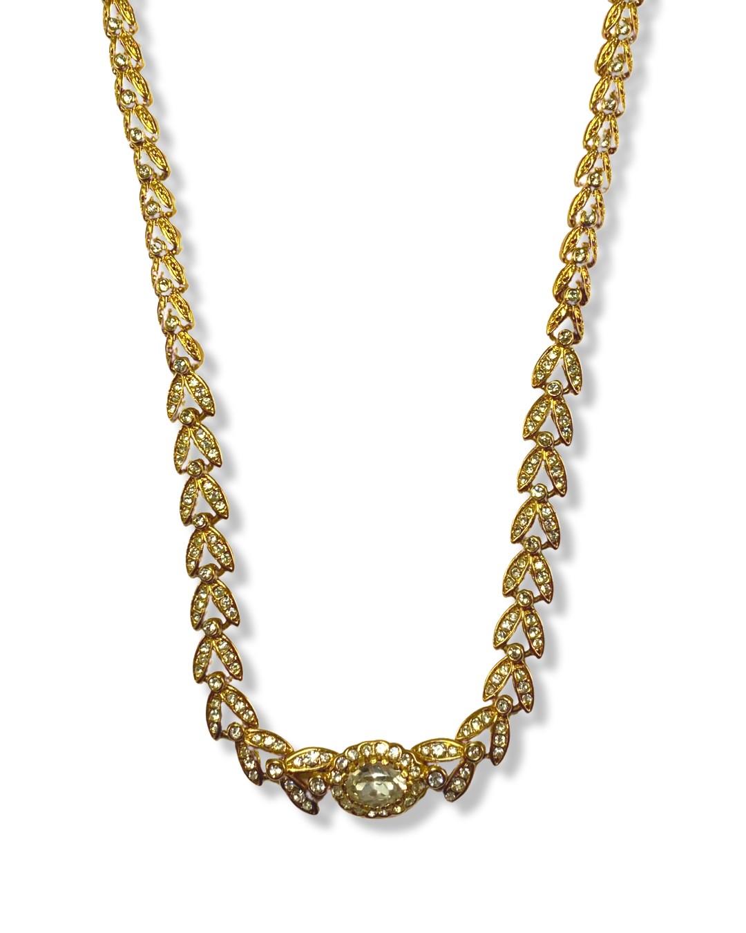 The Attwood collection suite featuring fancy design white stone on gold tone necklace, bracelet