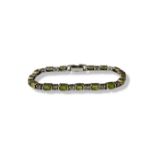 Two silver 925 bracelets, one featuring Peridots weighing 14.85 grams and 18.5cm in length. The X