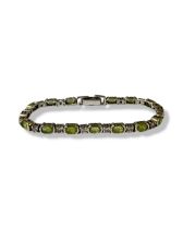 Two silver 925 bracelets, one featuring Peridots weighing 14.85 grams and 18.5cm in length. The X