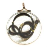A late Victorian gold locket pendant, containing locks of hair.