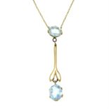 An early 20th century gold aquamarine pendant, on an integral trace-link chain.