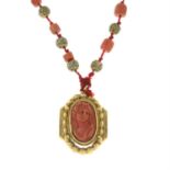 A coral cameo pendant, with coral beads and textured spacers.