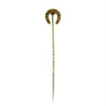 A late 19th century gold horseshoe stickpin.