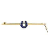 An early 20th century 9ct gold sapphire and diamond horseshoe bar brooch.