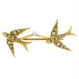 An Edwardian gold seed and split pearl bar brooch, depicting two swallows in flight.