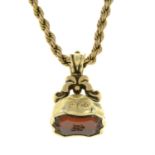 A late Victorian carnelian monogram seal fob, with gold rope-link chain.