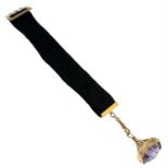 An early 20th century 9ct gold amethyst fob, with ribbon watch chain.