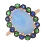 An opal ring, with sapphire and tsavorite surround.