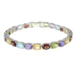 A silver multi-gem bracelet.