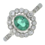 An emerald and brilliant-cut diamond cluster ring, with brilliant-cut diamond shoulders.