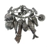 A late 19th century brooch, suspending eight charms.