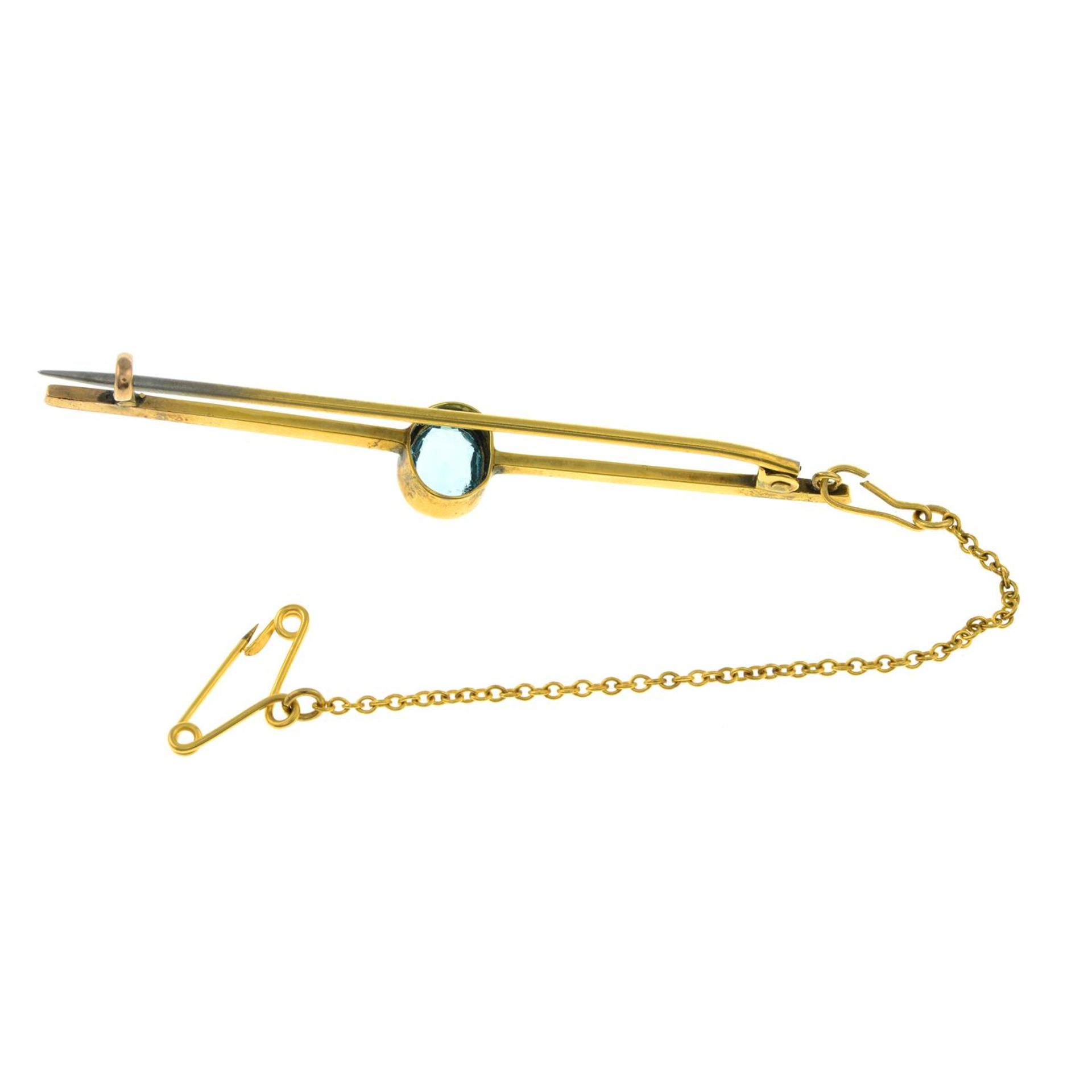An early 20th century 9ct gold blue paste single-stone bar brooch. - Image 2 of 2