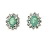 A pair of emerald and diamond cluster stud earrings.