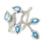 A silver blue topaz foliate dress ring, with textured band.