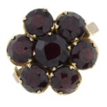 A garnet floral cluster ring.