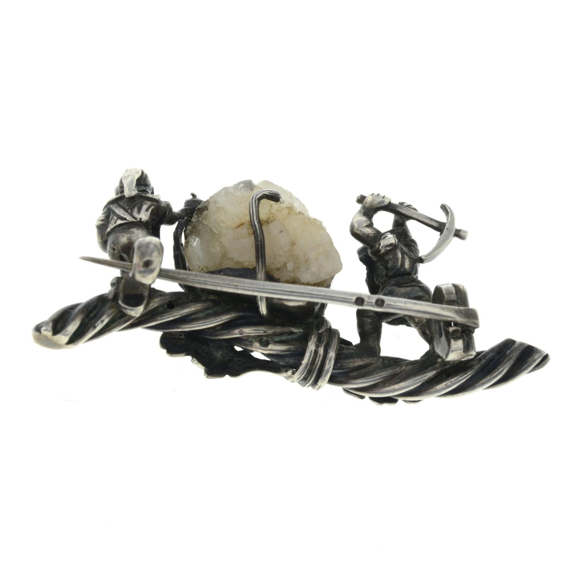 A late 19th century bar brooch, depicting two dwarves mining a pyrite laden quartz crystal, - Image 2 of 2