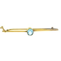 An early 20th century 9ct gold blue paste single-stone bar brooch.