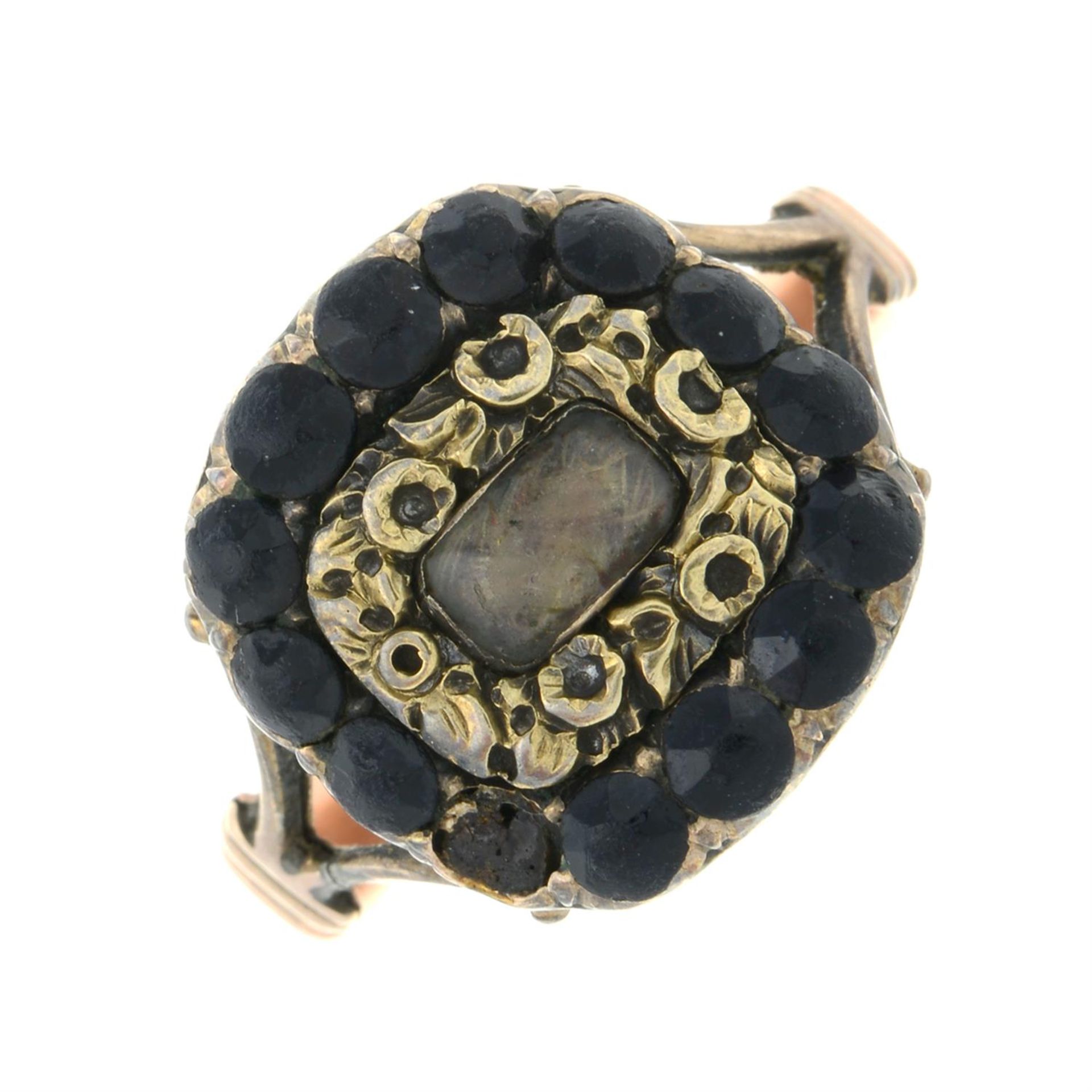 A Georgian gold black garnet and hairwork mourning locket ring.