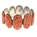 An early 20th century silver carved coral bracelet, depicting flowers and birds.