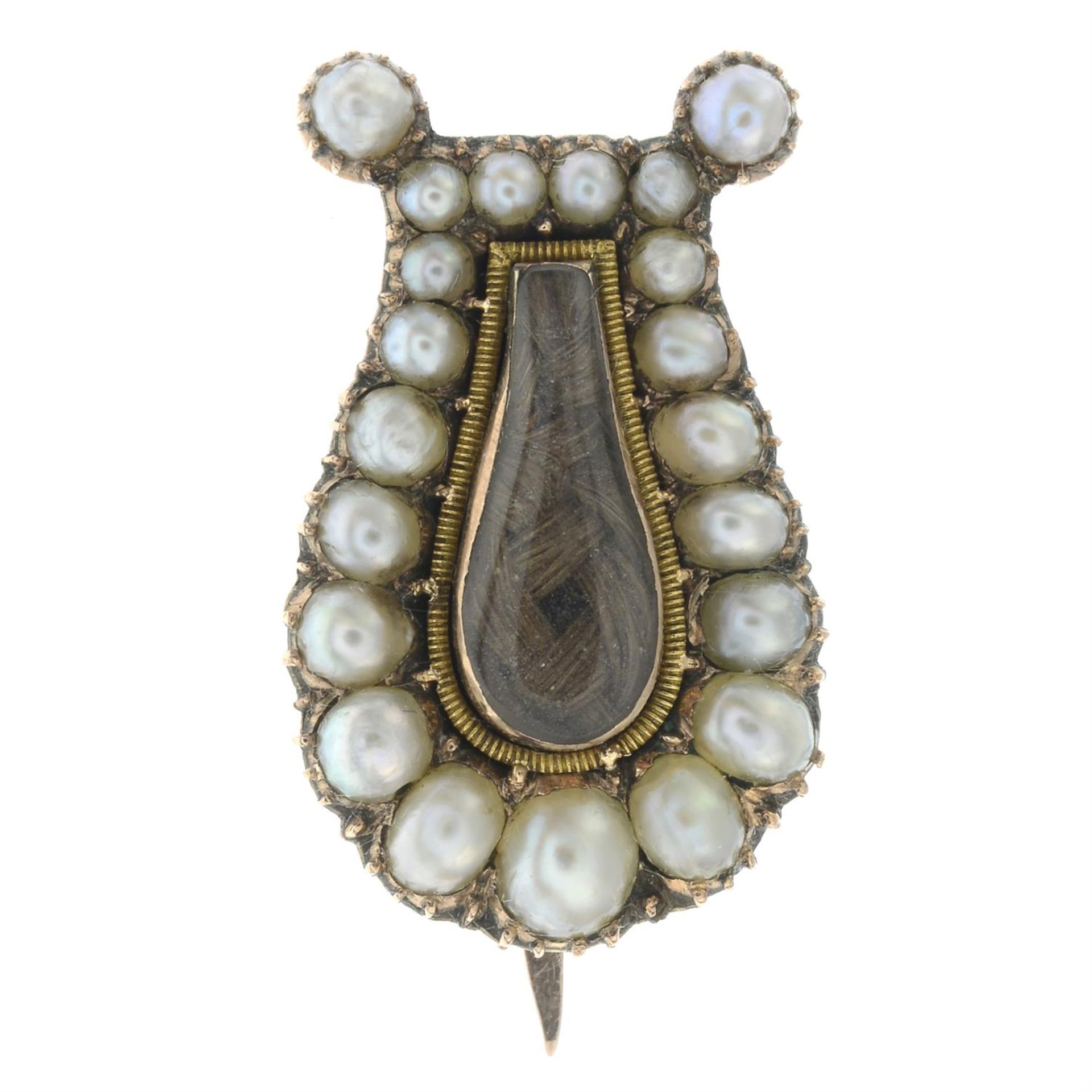 An early 19th century gold woven hair and split pearl memorial lyre brooch.