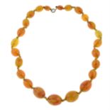 A graduated amber bead necklace.