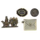 Four late Victorian and later items of jewellery, to include a black enamel mourning locket brooch,
