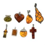 A selection of eight amber pendants.