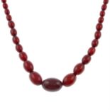 A red Bakelite single-strand bead necklace.