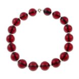 A red Bakelite single-stand bead necklace, with colourless paste spacers.