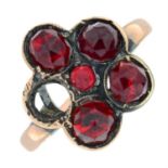 An early 20th century gold garnet floral cluster ring.