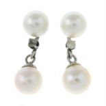 A pair of cultured pearl and diamond drop earrings.