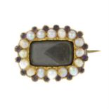 A Victorian 9ct gold split pearl and purple gem mourning brooch.