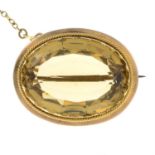 An Edwardian oval-shape citrine brooch, with safety chain.