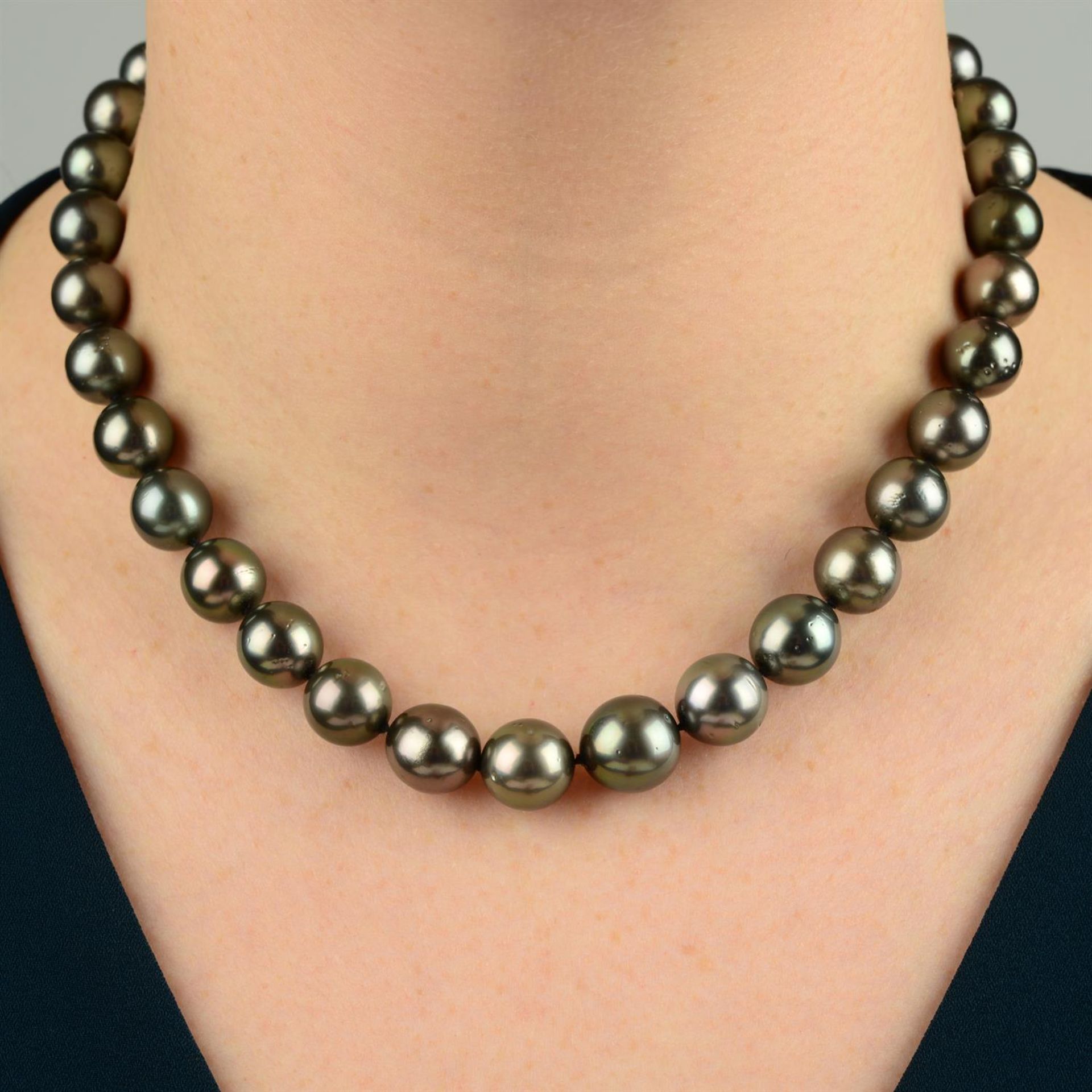 A graduated cultured pearl necklace, with a brilliant-cut diamond clasp.