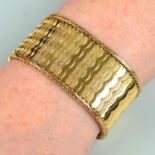 A mid 20th century textured and polished 18ct gold bracelet.