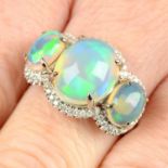 An opal three-stone and diamond ring.
