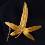 An early 20th century 15ct gold split pearl Blue Passion Flower leaf brooch.