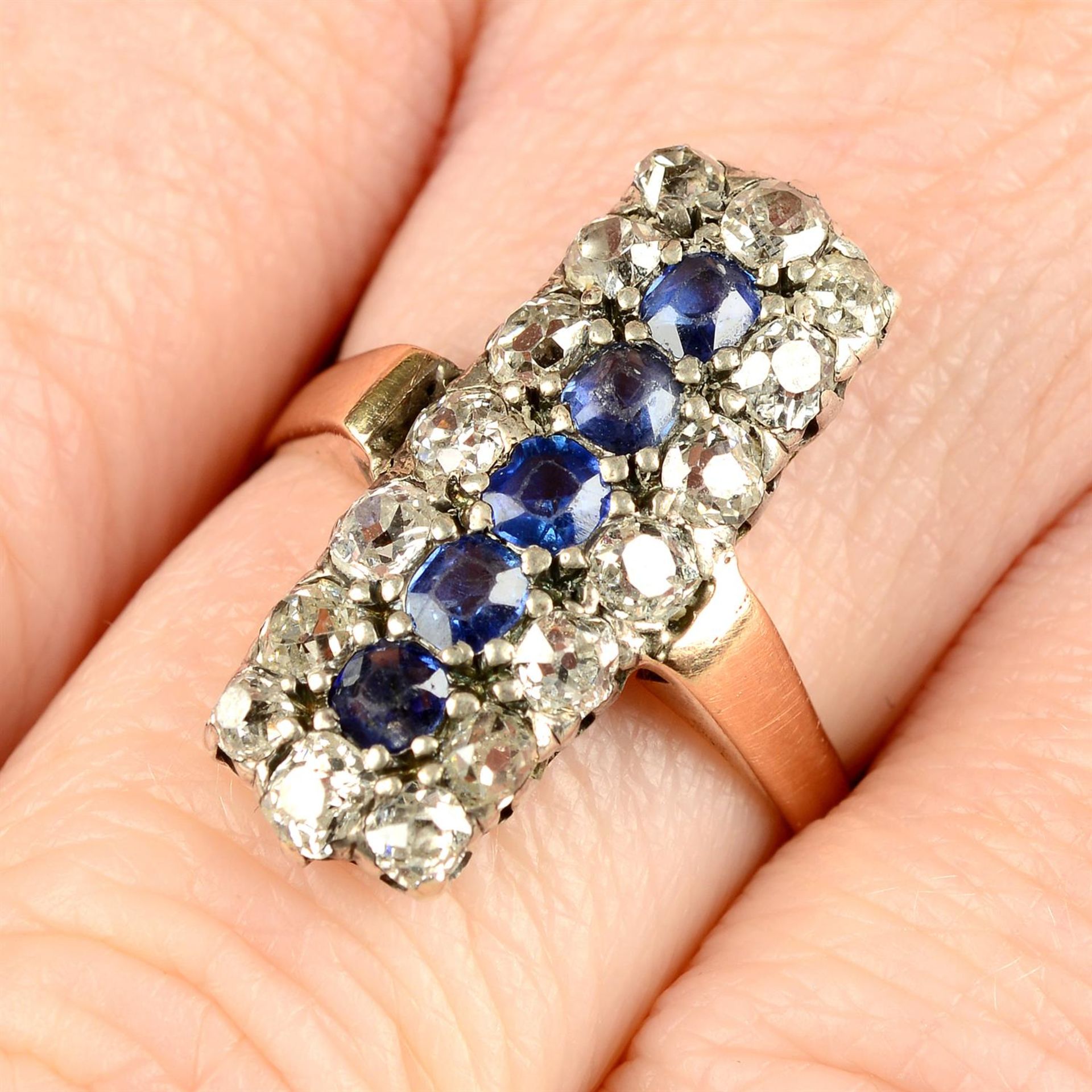 An early 20th century silver and gold old-cut diamond and sapphire dress ring, with replacement