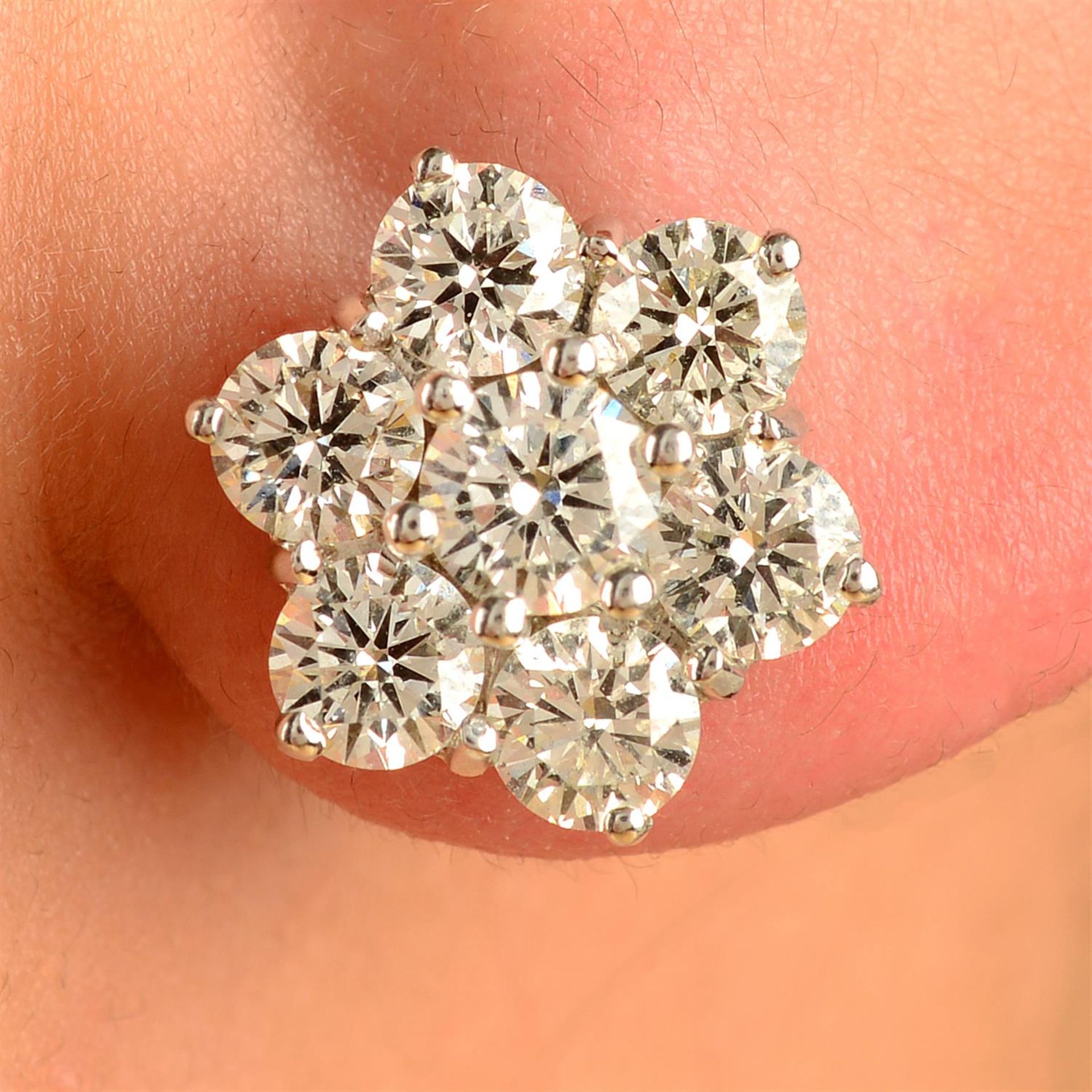 A pair of 18ct gold brilliant-cut diamond floral cluster earrings.