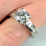 A brilliant-cut diamond single-stone ring, with brilliant-cut diamond line sides.
