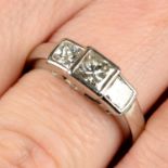 A platinum square-shape diamond three-stone ring.