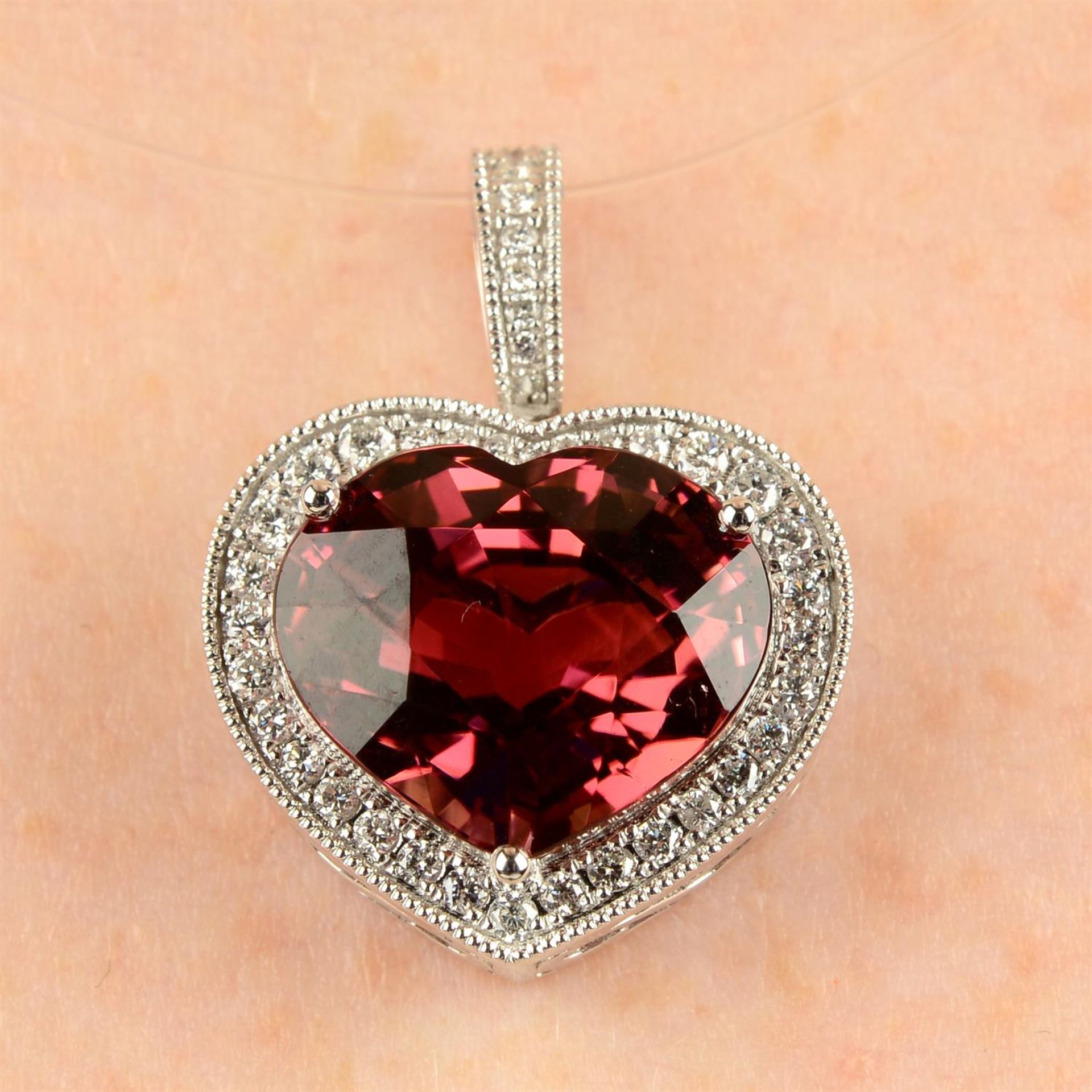 An 18ct gold pink tourmaline and brilliant-cut diamond heart-shape pendant.