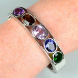 A hinged bangle, with amethyst, morganite, iolite and further collet-set gems.