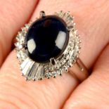 A sapphire cabochon and vari-cut diamond cluster ring.