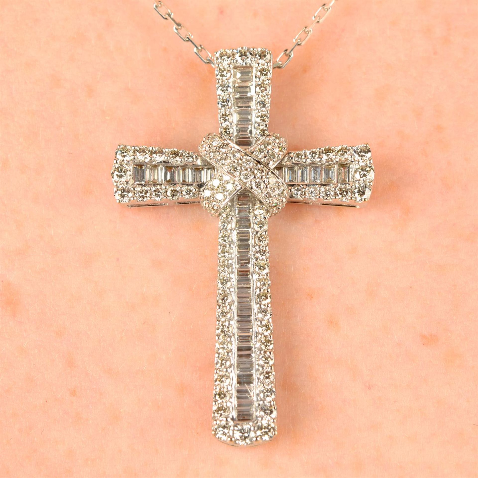 A baguette and brilliant-cut diamond cross pendant, with 18ct gold chain.