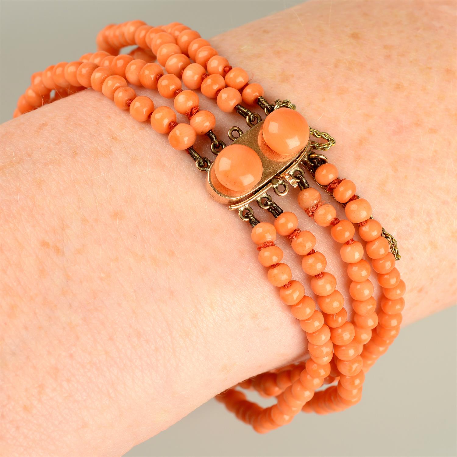 A 19th century gold coral four-strand bracelet.