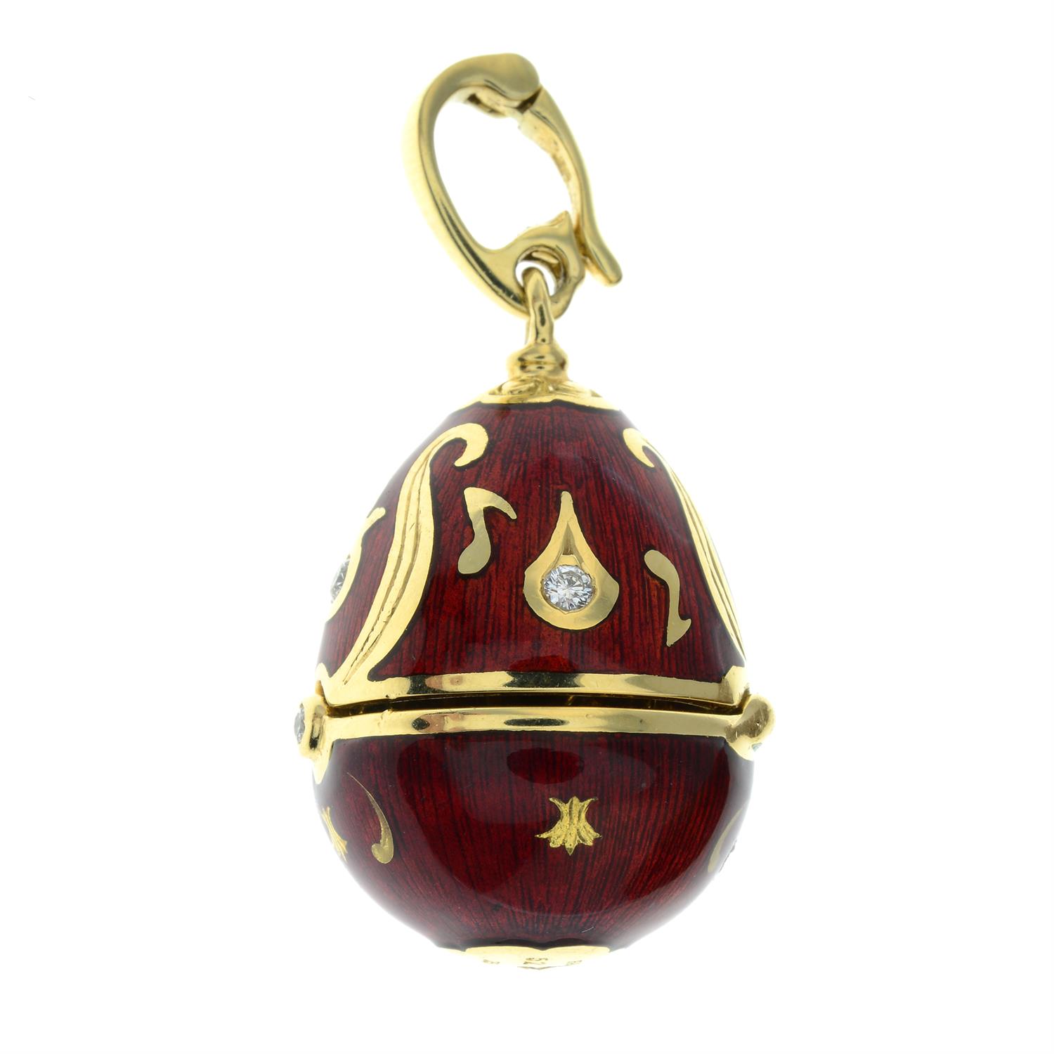 A limited edition 18ct gold diamond and red enamel hinged egg pendant, containing a treble clef, - Image 3 of 5