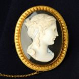 A mid to late 19th century gold agate cameo brooch, carved to depict a woman in profile.