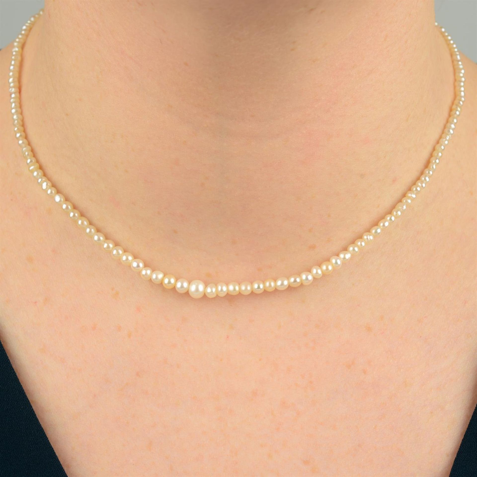 A natural pearl necklace, with old-cut diamond cluster clasp.